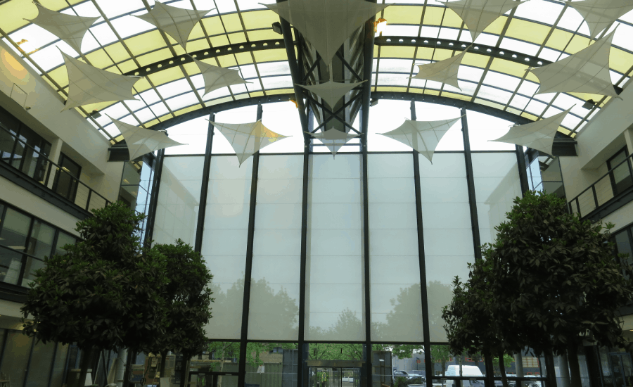 Kite shaped fabric sun screens in office