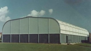 Fabric cladding to a portal frame system